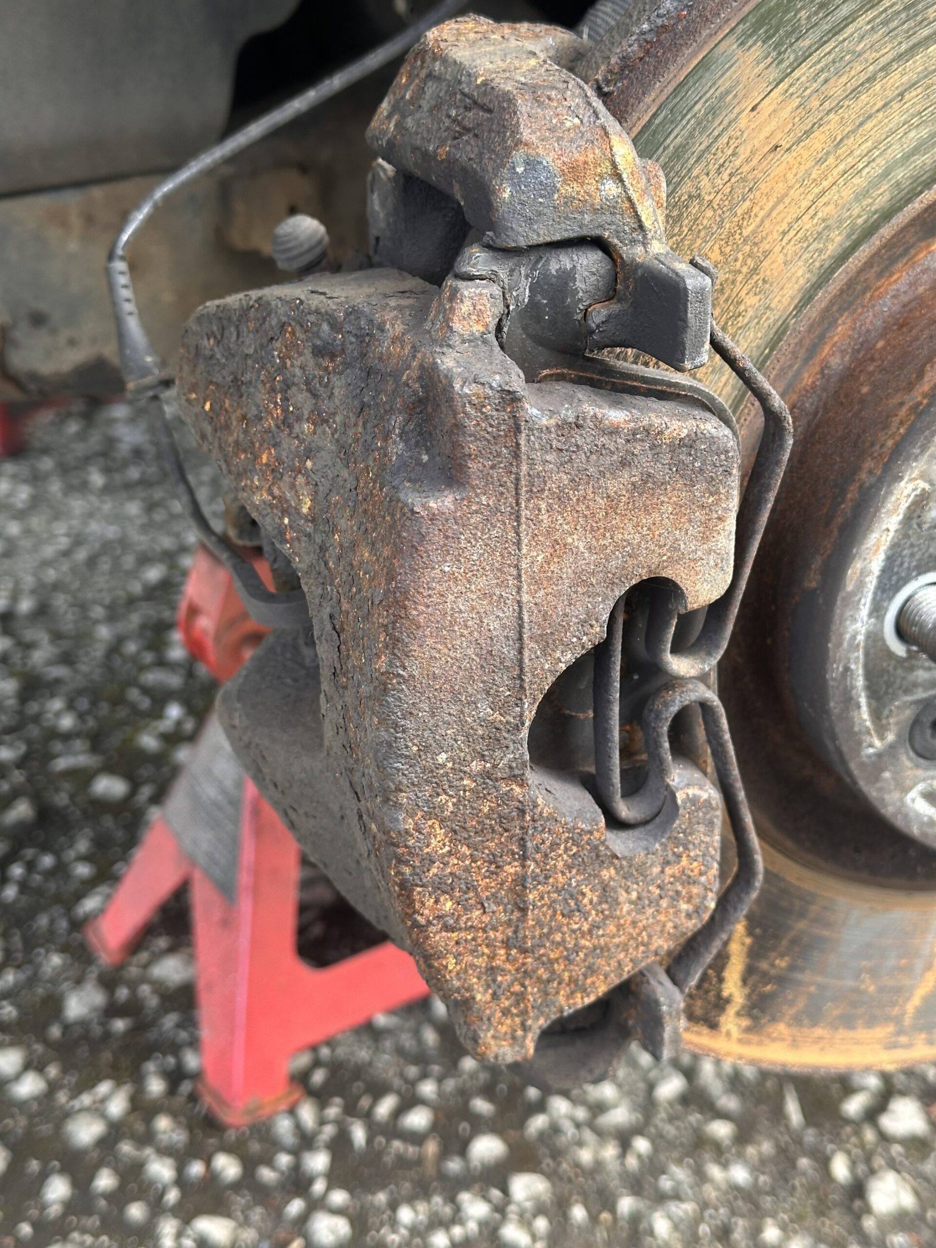 Before brake caliper painting showing heavy corrosion and surface rust