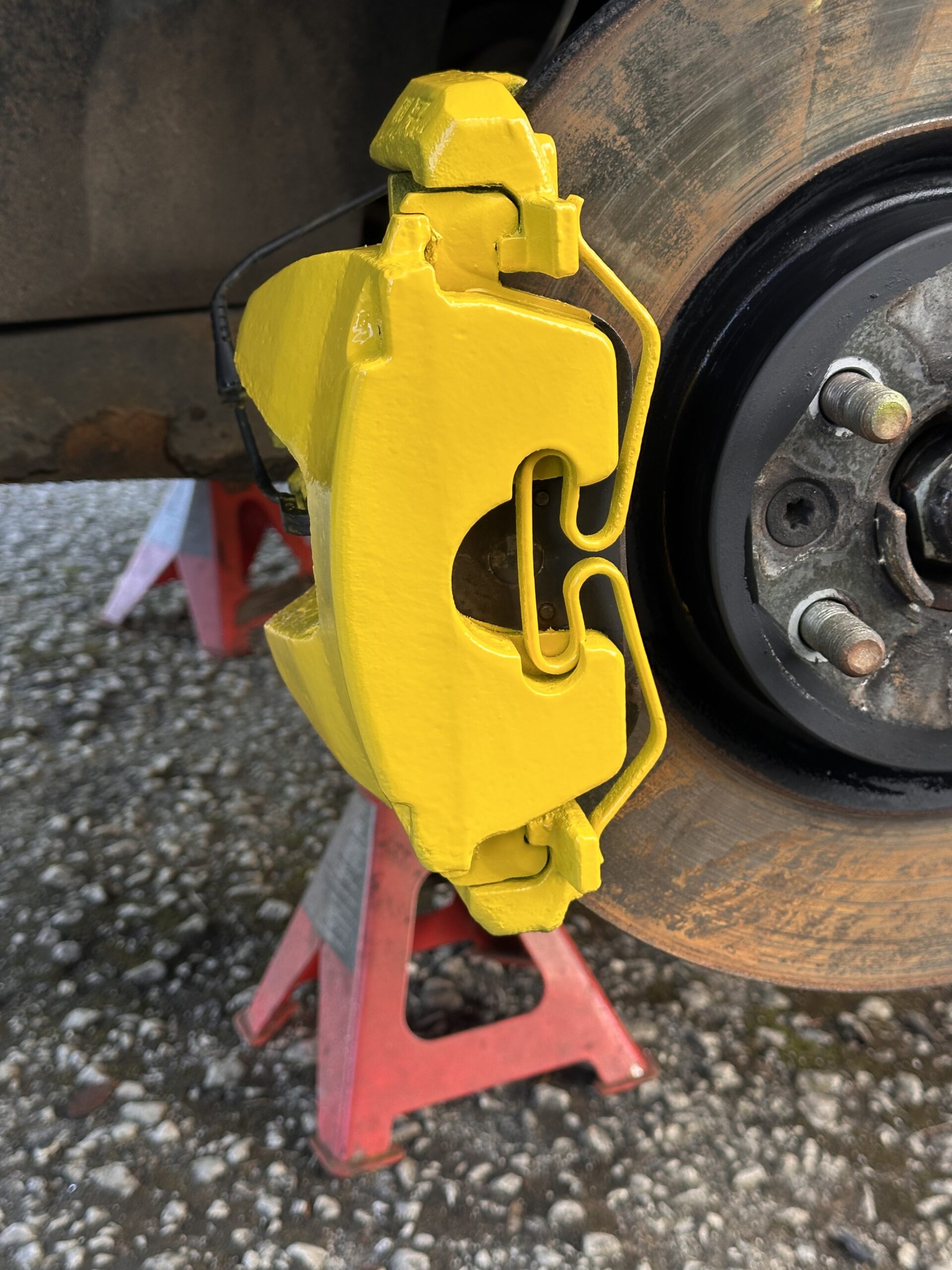 After brake caliper painting in high gloss yellow with a fresh professional finish